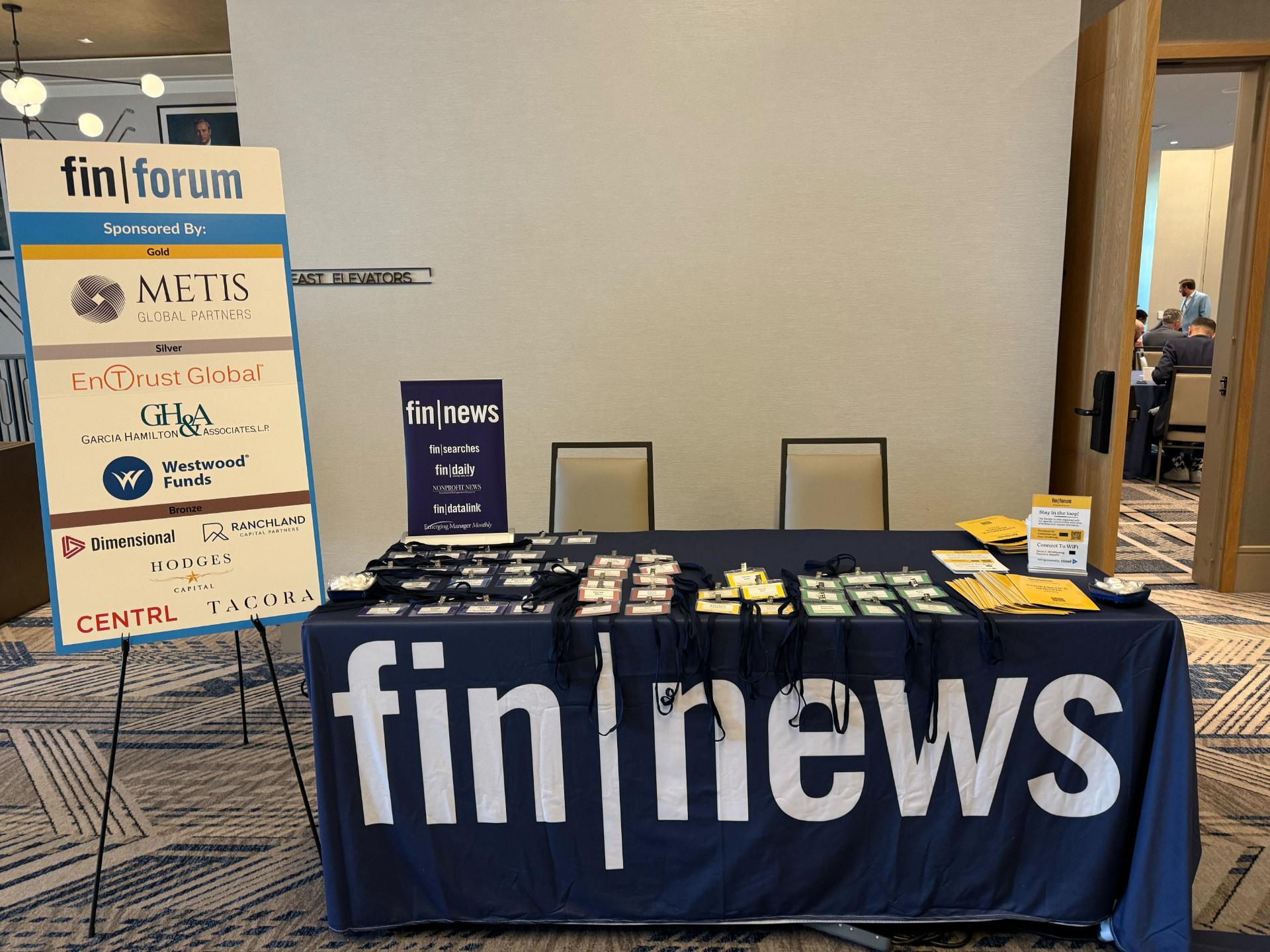 FIN Forum sponsor signage beside the fin|news registration table