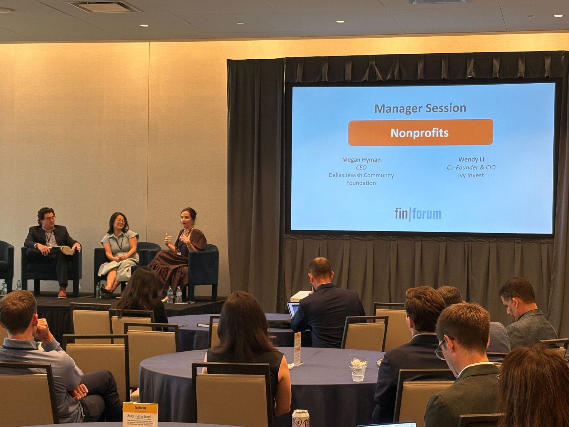 Manager session panel on stage at FIN Forum with a full audience