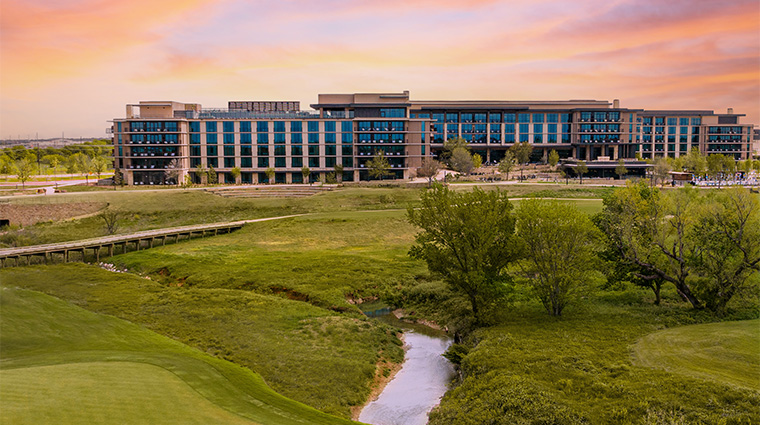 The Omni PGA Frisco Resort at sunset above the fairways